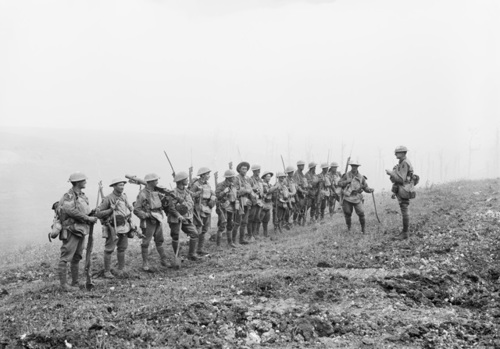 A row of Australian World War One infantrymen is addressed by their Lieutenant.