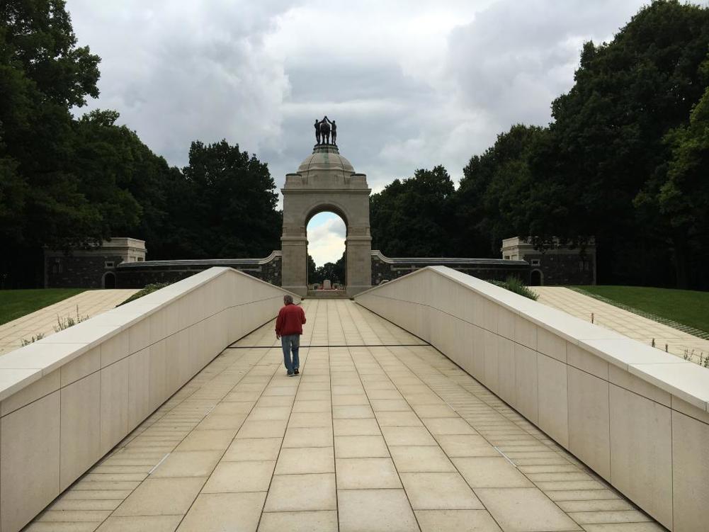 Visitor the Delville Wood Memorial inspects the Memorial Wall