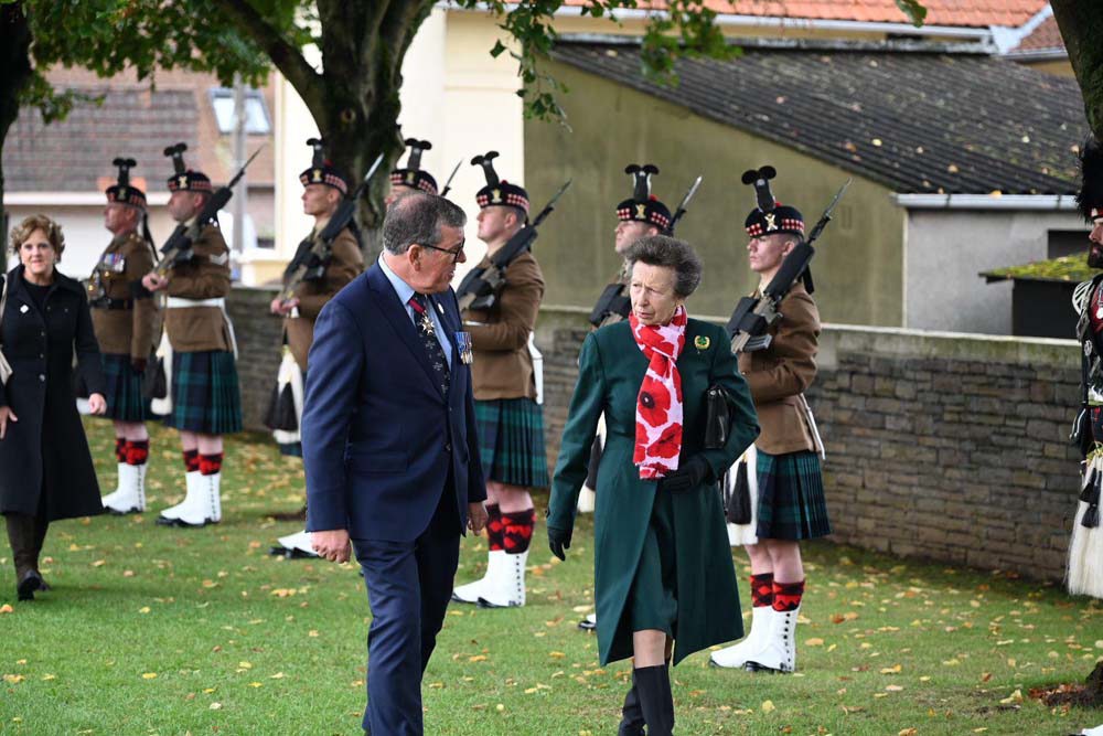 Princess Anne walks past Scots Guards at Loos British Cemetery