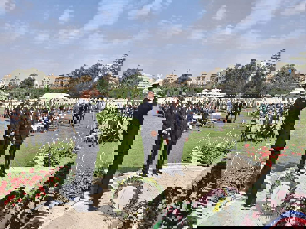 Figures pay their respects to the fallen at Heliopolis War Cemetery, Egypt