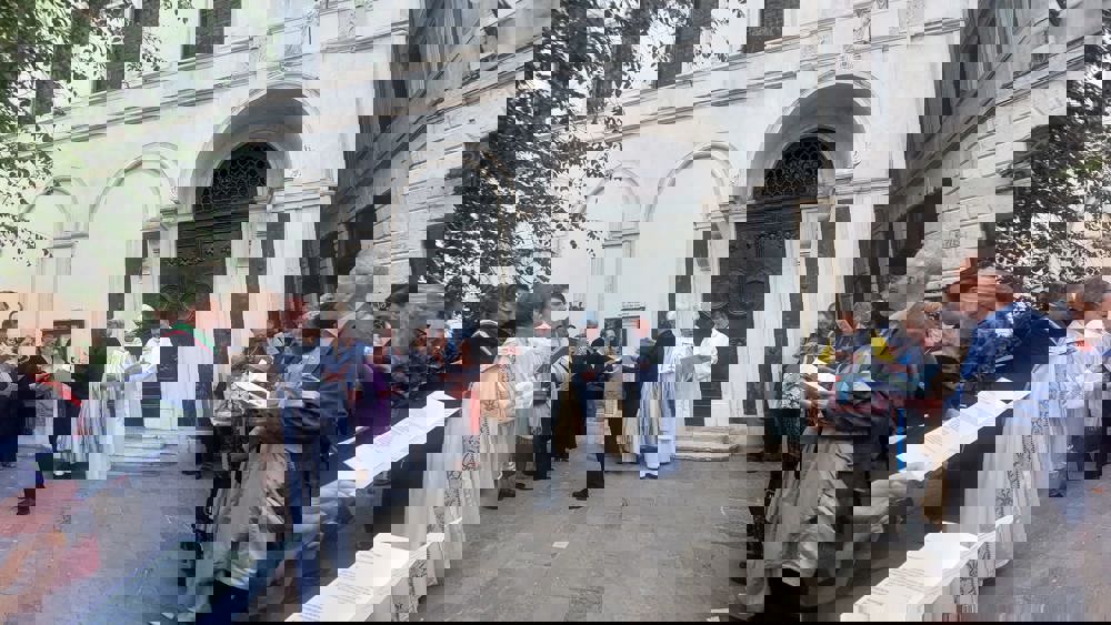 Guests outside St George's Anglican Church singing hymns.