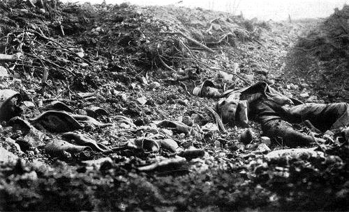 A corpse of a soldier lies amongst rubble and detritus on a WW1 battlefield.