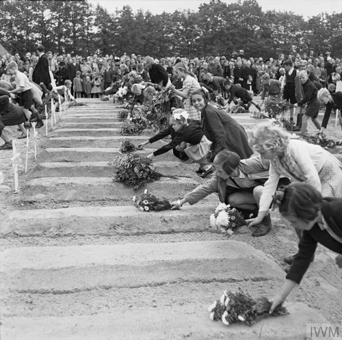 Flower girls lay flowers on the graves in Oosterbeek War Cemetery, circa 1945