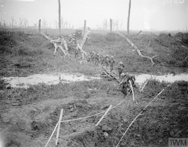 Soldiers navigating muddy ground on duckboards during the Battle of Passchendaele