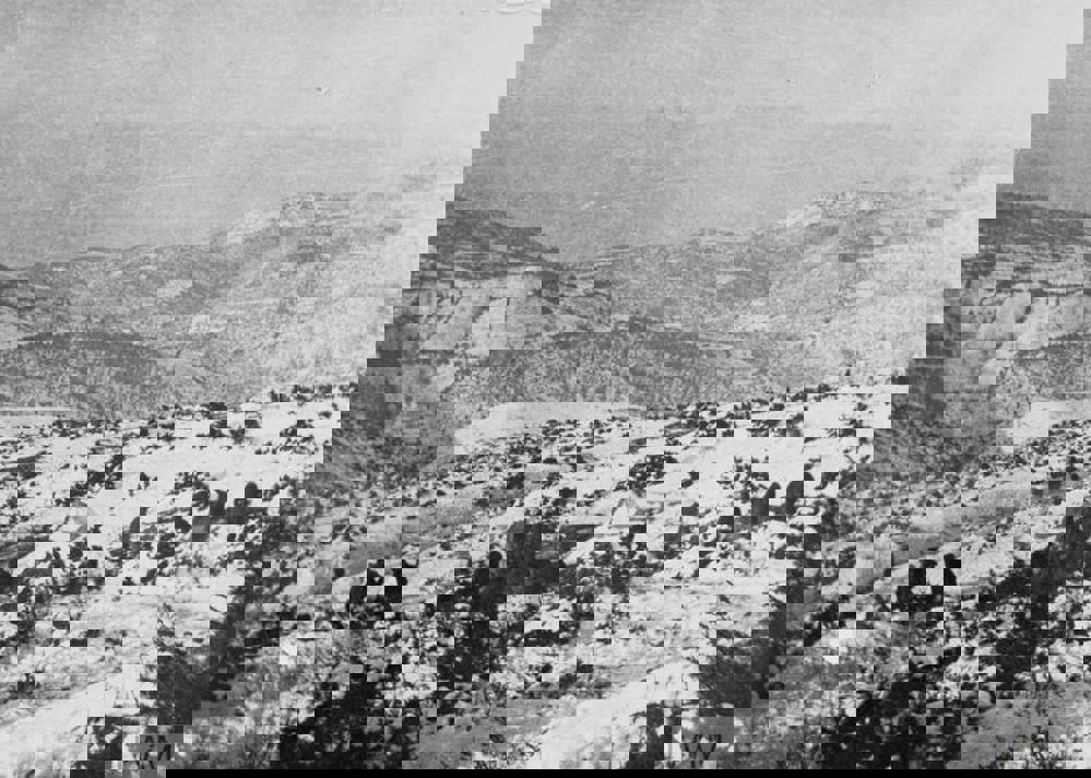 HQ of the Connaught Rifles tucked in the hills of Salonkia. A number of soldiers' silhouettes are visible against the snow but the HQ tents are hard to discern.