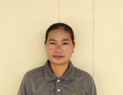 Portrait of Kannockkorn in her CWGC gardener's uniform against a cream background.