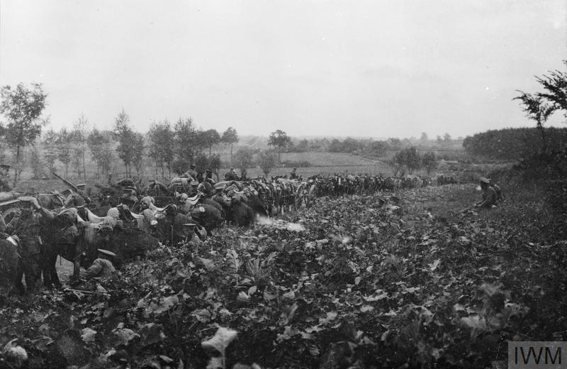 Northumberland cavalrymen resting next to a churned up field at Ypres.