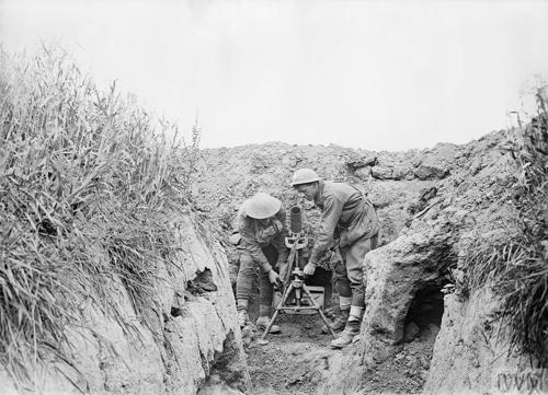 A pair of World War One  Australian soldiers within a trench, operating a mortar.