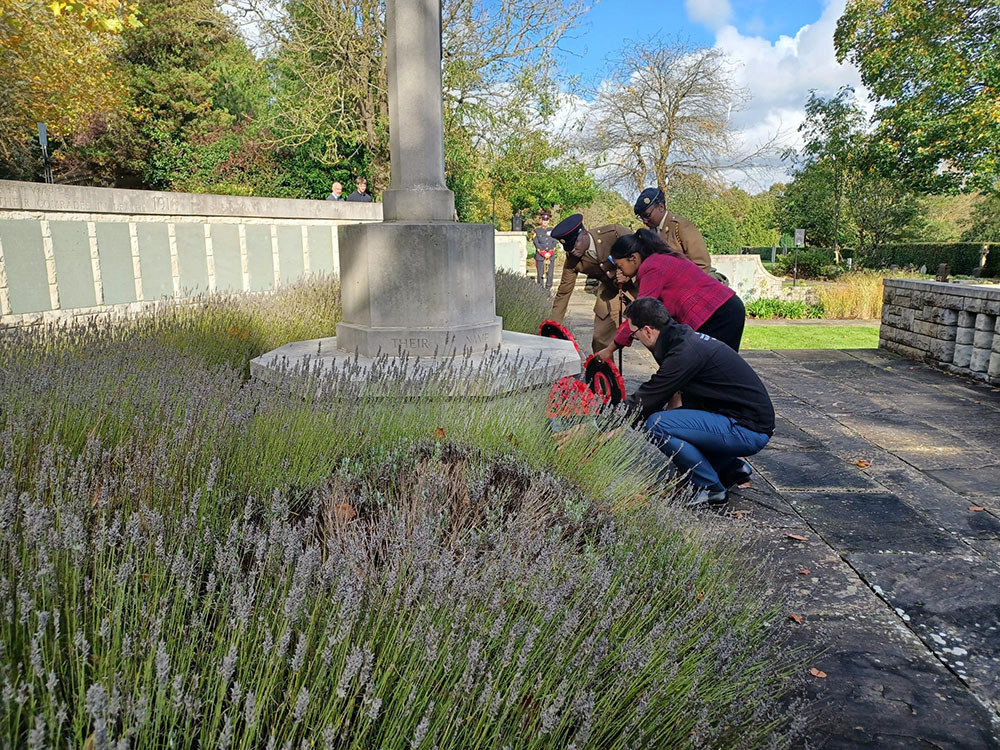 Black British Army personnel lay a wreath on the Cross of Sacrifice at the Hollybrook Memorial, Southampton