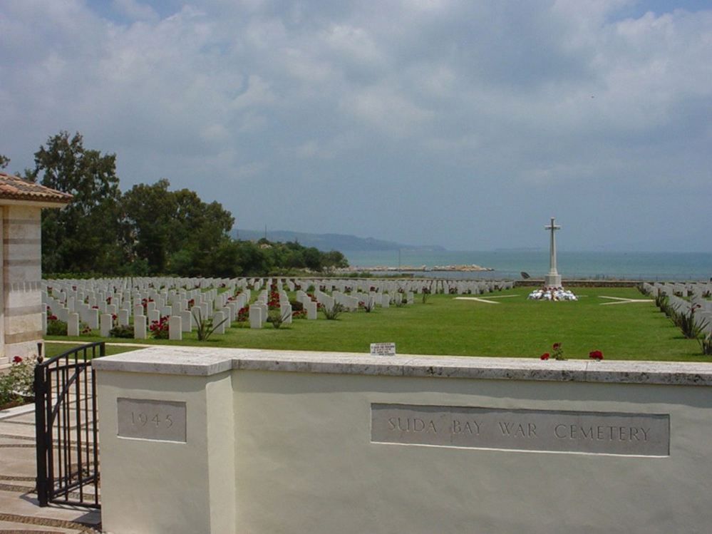 Headstones and Cross of Sacrifice overlooking the Aegean Sea at Suda Bay War Cemetery.