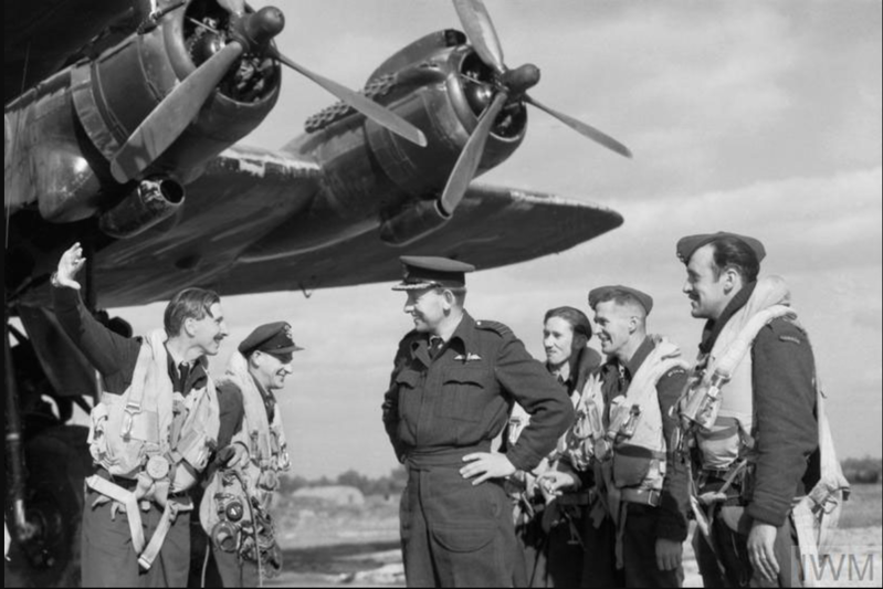 Wing Commander Harrison (far left) describes the situation over Arnhem