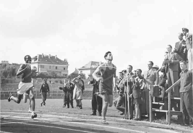 Two athletes crossing the finishing line at an Armed Forces athletics event during the First World War.