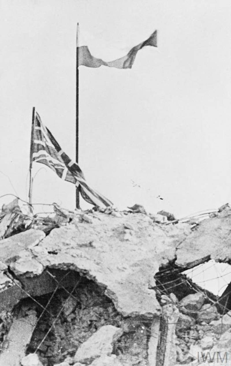 British and Polish flags flying over the rubble at Monte Cassino