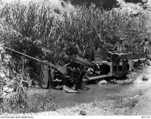 A damaged Turkish artillery piece lies on its side in a muddy puddle during the Battle for Jericho.