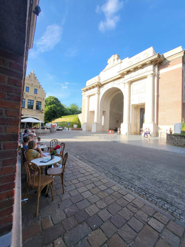 View of the Menin Gate from coffee tables set up outside the CWGC Visitor Centre.