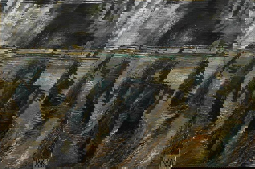 Painting showing British soldiers wading through a flooded paddy during the Battle of the Sittang Bend. The painted monsoon sky is very dark while ripples can be seen in the wake of the advancing soldiers.