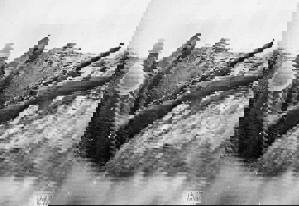 British soldiers digging in rocky ground to deepen a trench during the Battle of Lake Doiran. They have rest their rifles on the edge of the trench.