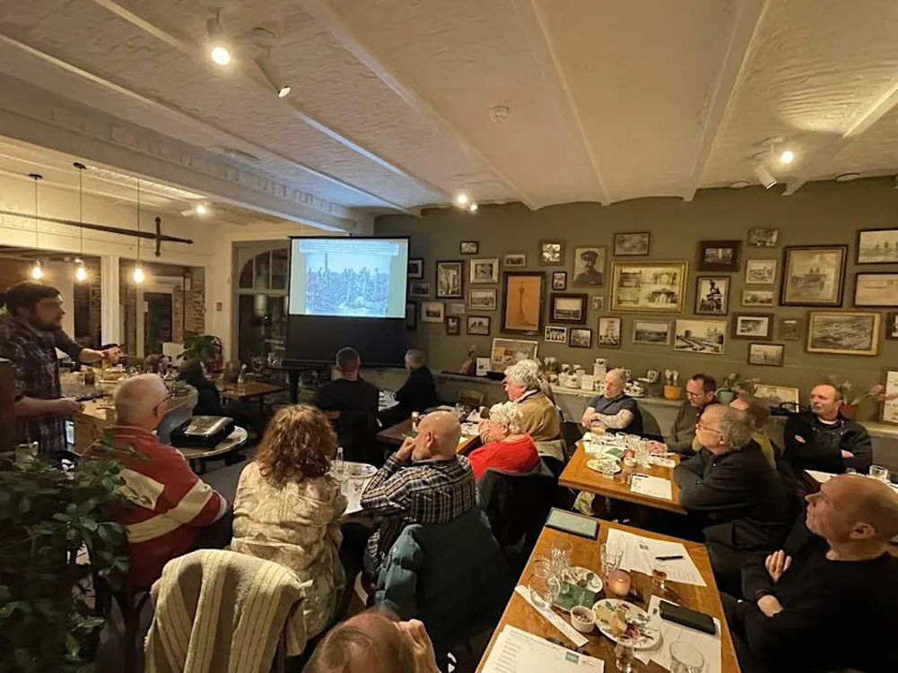 Guests listening to a speaker giving a talk at the Ieper Visitor Centre.