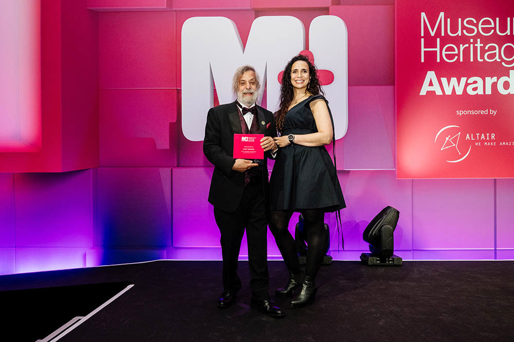 Nick Ezra, left, accepts an award at the Museum and Heritage Awards.
