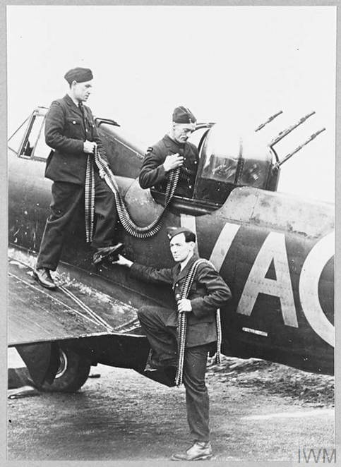 Newfoundland armourers at work on the squadrons aircraft (standing on the wing) A/C Bill Rogers of Marystown; in turret A/C Eric Calver of St. Johns; and LAC "Hank" Ploughman of Port Rexton. © IWM (CH 4606)