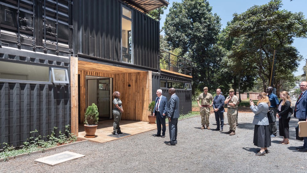 Speaker of the House Lindsey Hoyle speaks with CWGC staff outside their new Nairobi office.