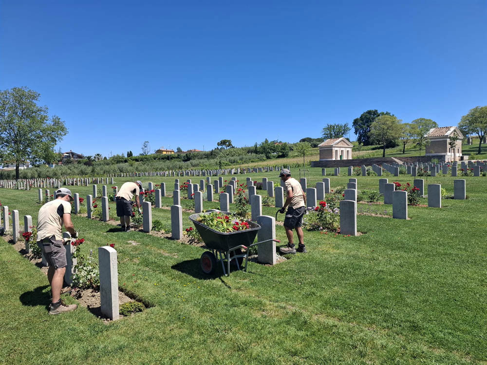 CWGC Gardeners working on plant borders at Coriano Ridge War Cemetery.
