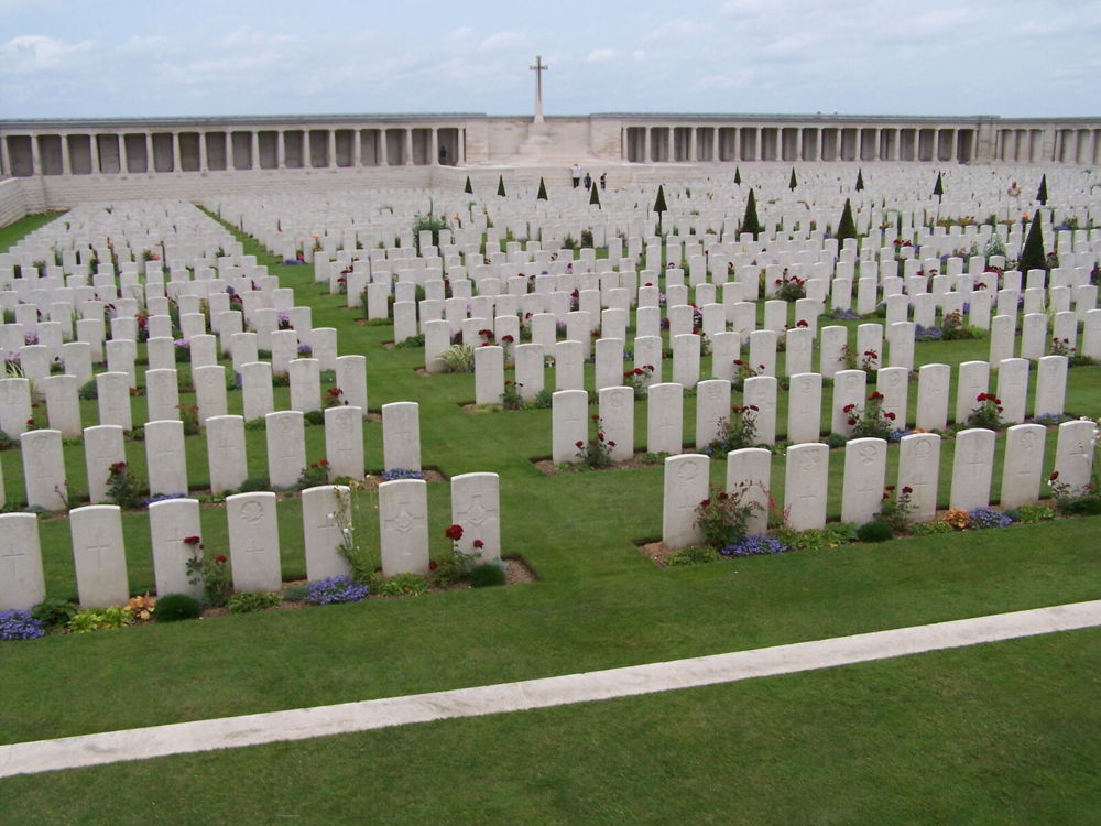 Rows of headstones leading up the the curtain wall memorial at Pozieres British Cemetery.