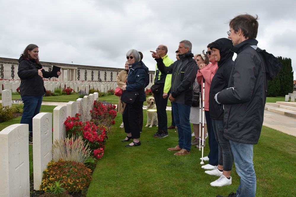 CWGC tour guide speaking to guests at Tyne Cot Cemetery.