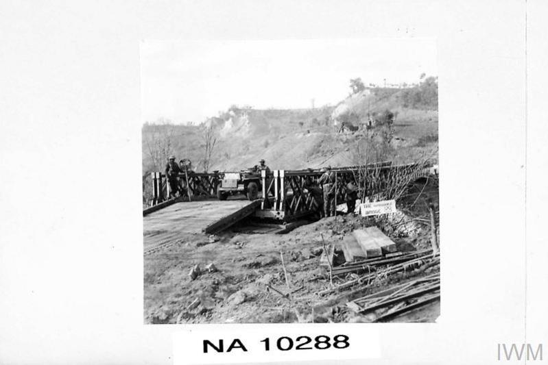 A military bridge spanning the Moro River. On the bridge stand Indian Army engineers.