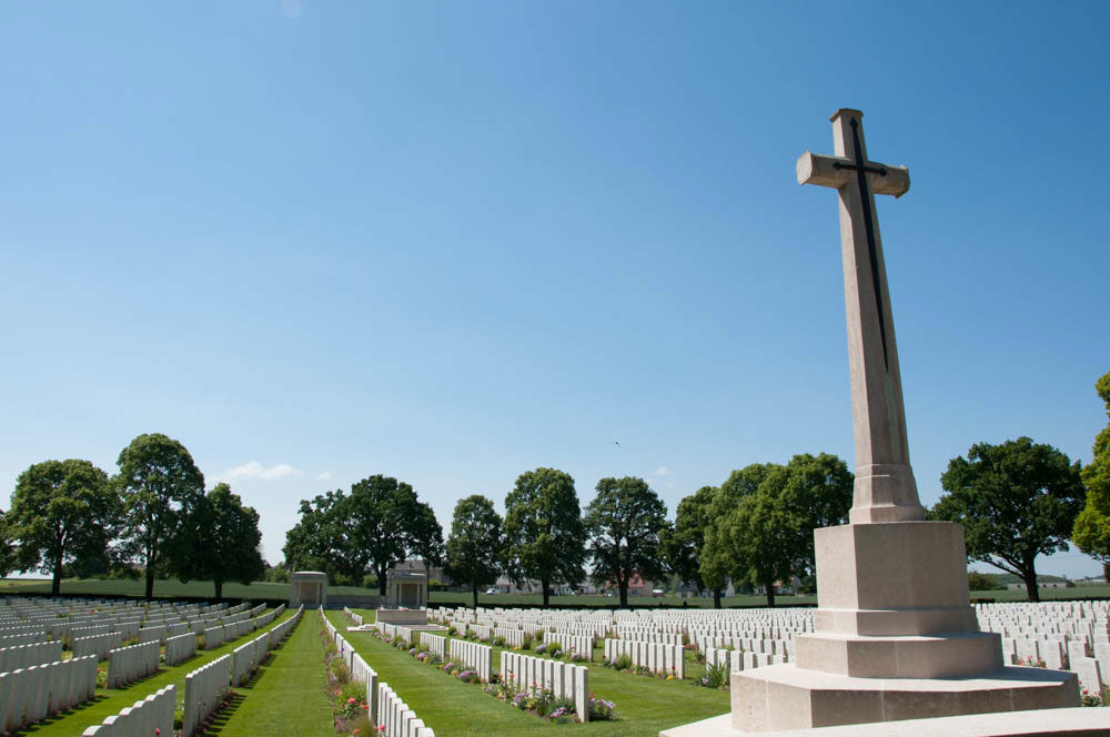 Cross of Sacrifice and headstone rows at Delville Wood Cemetery