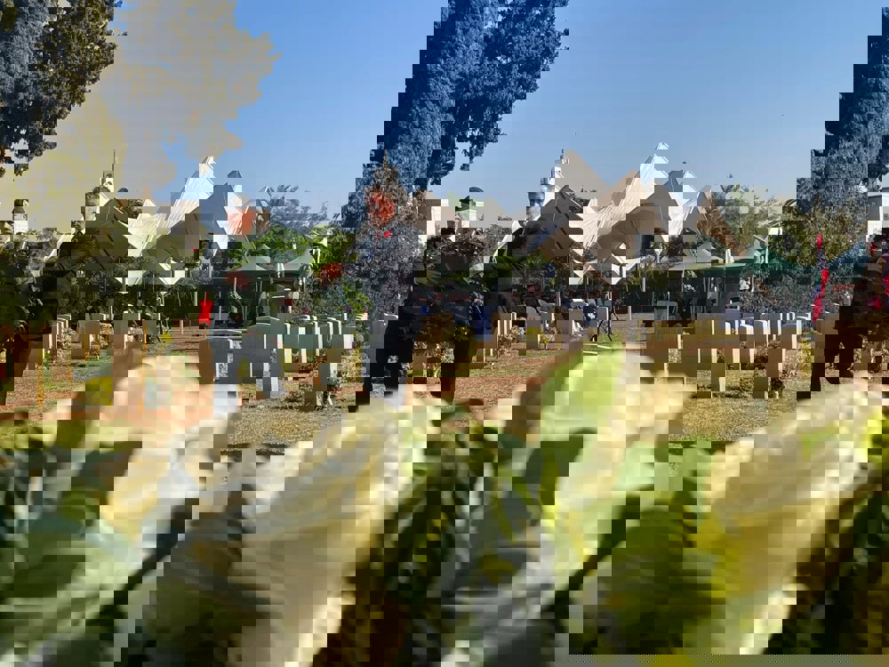 Two men carry a wreath on their way to lay it on the steps of a war memorial in Beirut.