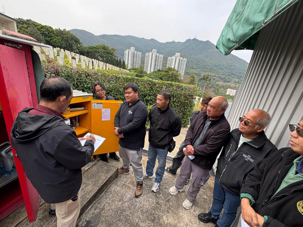 Staff at Sai Wan War Cemetery receiving a briefing.