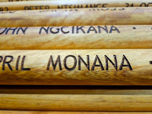 The names of Black South African Labour Corps personnel carved into Iroko wood posts for use in the Cape Town Labour Corps Memorial