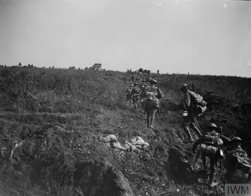 Australian WW1 soldiers marching with their packs and rifles towards the frontline.