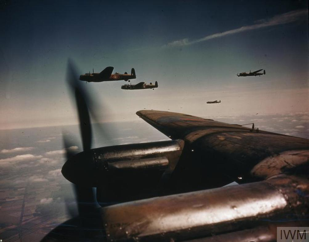 A colourised picture of a squadron of RAF Lancaster Bombers formation flying over Europe.