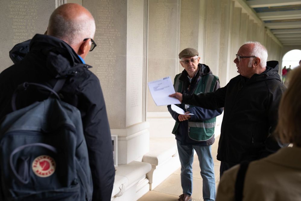 A tour guide speaking to visitors to the Runnymede Air Forces Memorial.