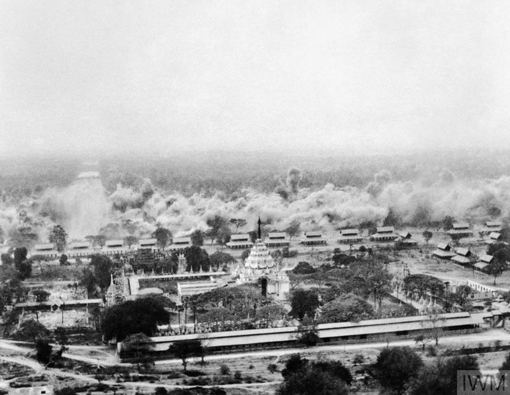 Panoramic view of a central Pagoda and Temple in Mandalay after its been hit by Allied bombing circa 1945. Smoke clouds from the bombing are visible rising through the air.