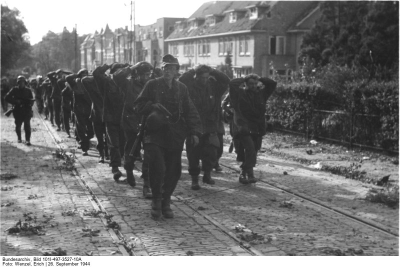 British POWs are marched through the streets of Arnhem by German guards