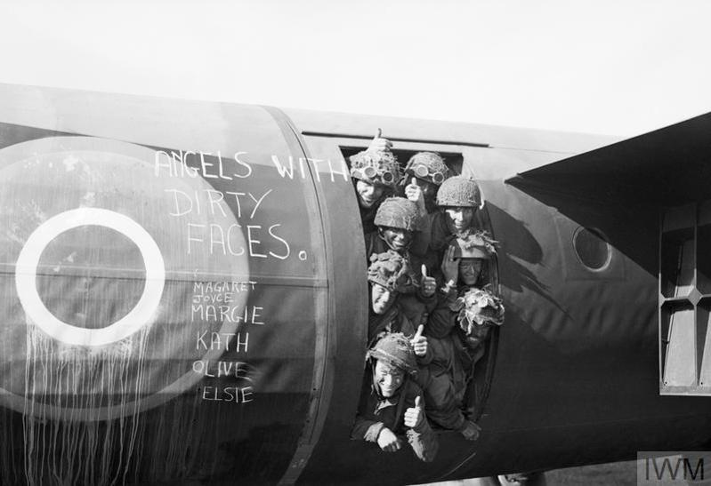 Paratroopers pose in the hatch of their glider on D-Day. "Angels with Dirty Faces" has been written on the side of the Horsa Glider.