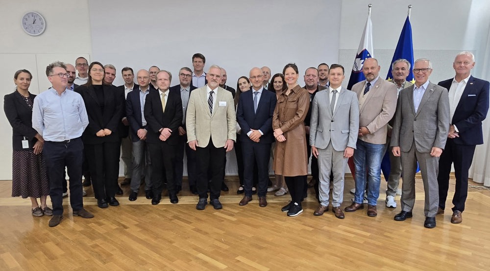 Group of diplomats posing for the camera in a conference room.