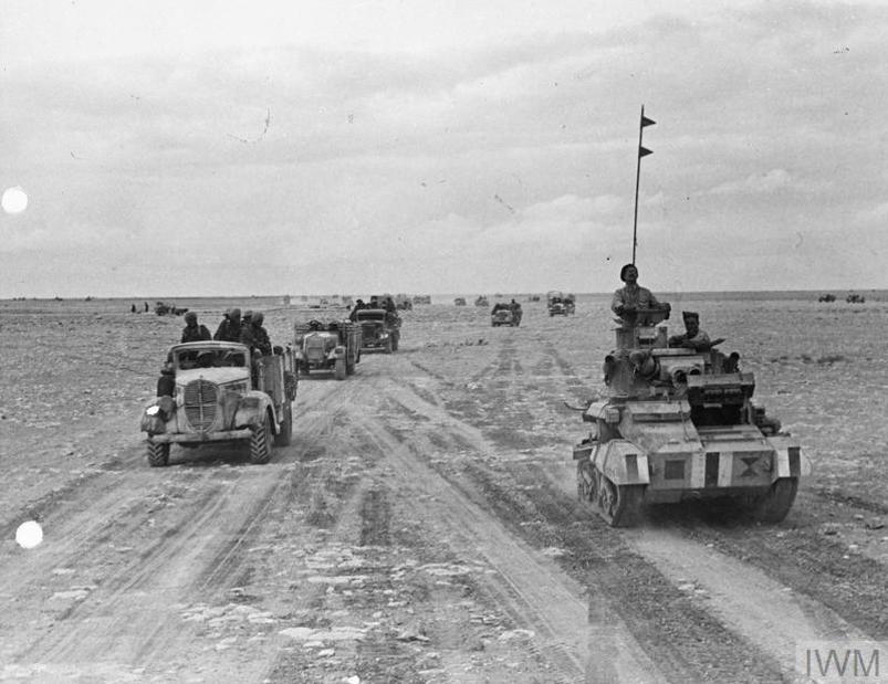 Indian Army trucks and tanks speed across the desert