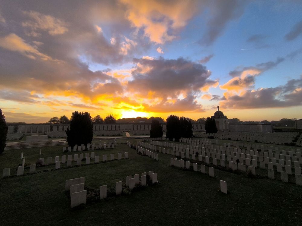 Tyne Cot Cemetery as a low autumnal sun sets over the cemetery