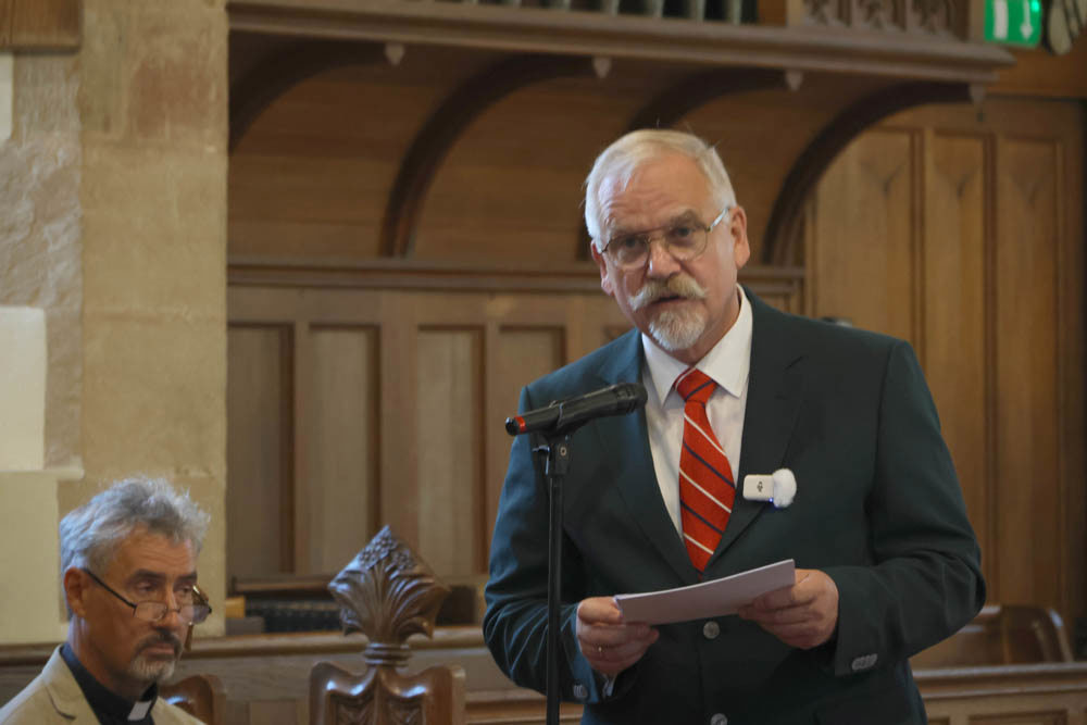 Man gives a speech inside a churh.