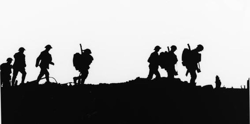 First World War soldiers silhouetted against the sky.