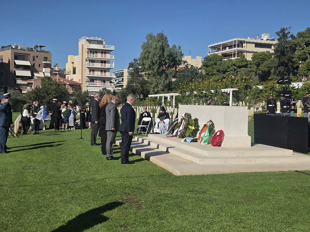 Diplomats bow their heads in respect at the Stone of Remembrance in Phaleron War Cemetery, Greece