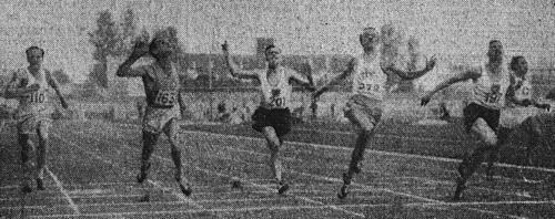 A grainy photo of sprinters crossing the finishing line at a race in Paris circa 1938.