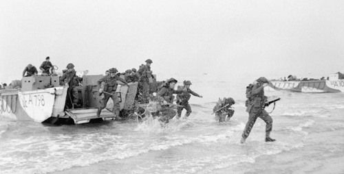 Service men on D-Day reach the beach