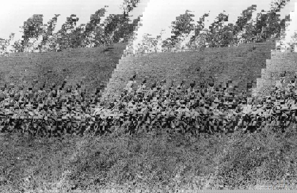Squad of King's African Rifles soldiers resting on an embankment somewhere in Tanzania circa 1917.