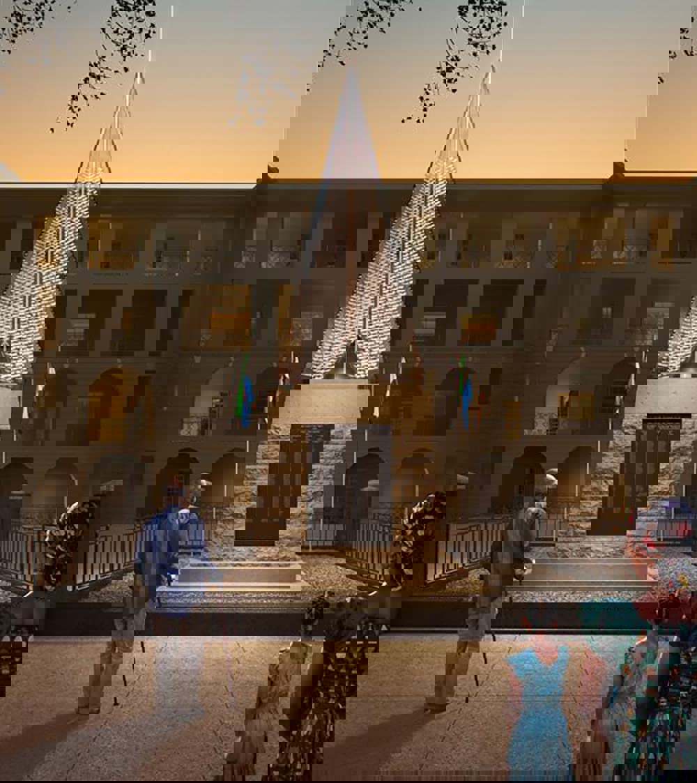 Artists impression of addition to Sierra Leone Carrier Corps Memorial. The new addition is a glass pyramidal structure sittng atop the existing rectangular memorial. Etched into the glass are the names of Carrier Corps servicemen. A beam of light shines up through the pyramid into the sky.