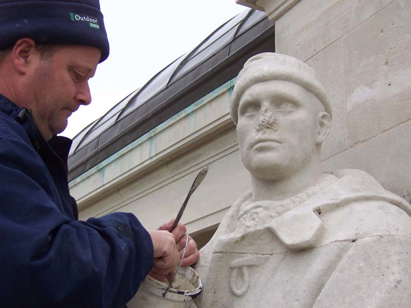 CWGC craftsman making repairs to a statue at Chatham Naval Memorial